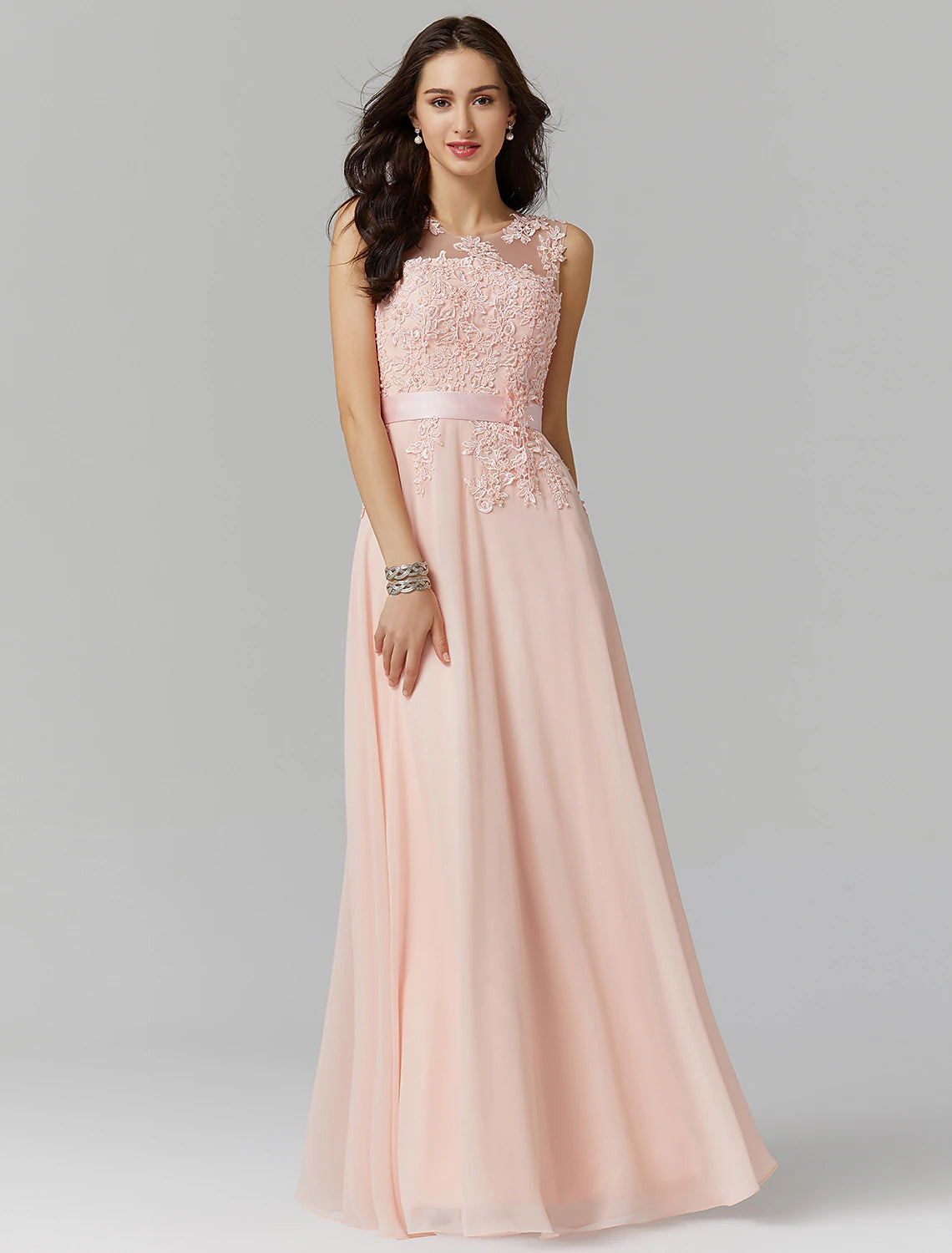 Model wearing an elegant A-line evening gown with an illusion neckline.