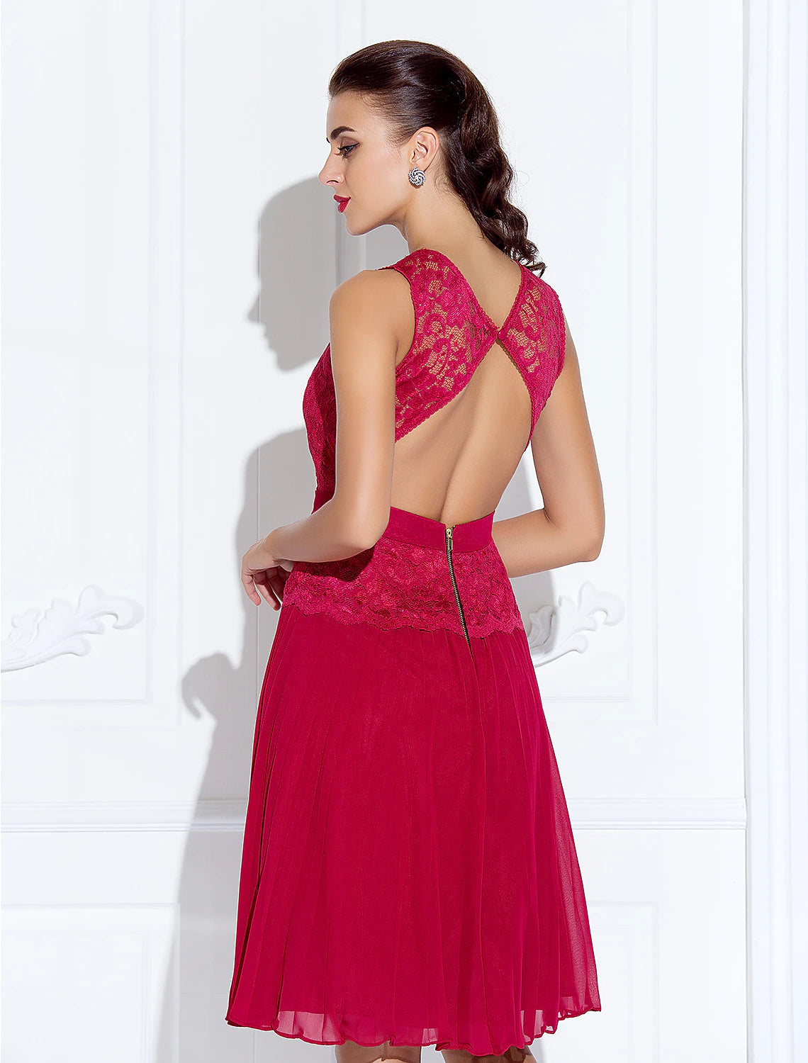 Woman posing in the A-line illusion neck cocktail dress, showing movement.