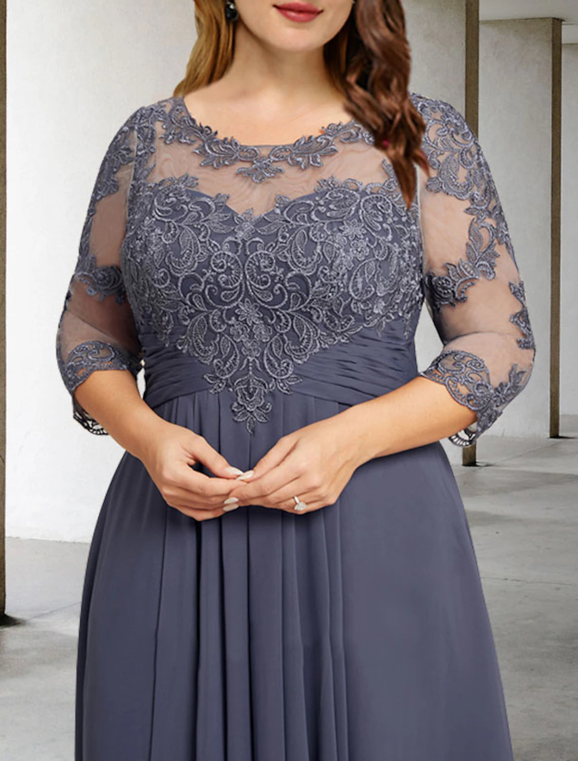 Back view of the formal A-line gown with pleats and appliques.
