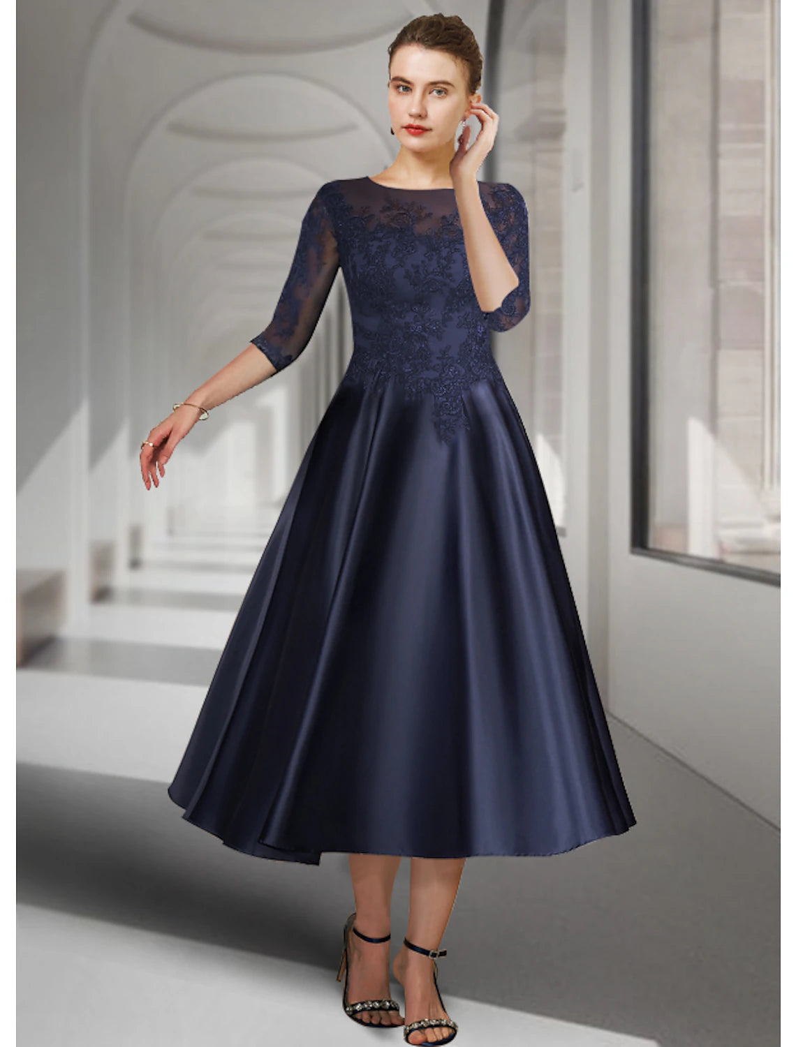 Elegant A-Line tea length dress with jewel neck and 3/4 sleeves, featuring satin lace and appliques.