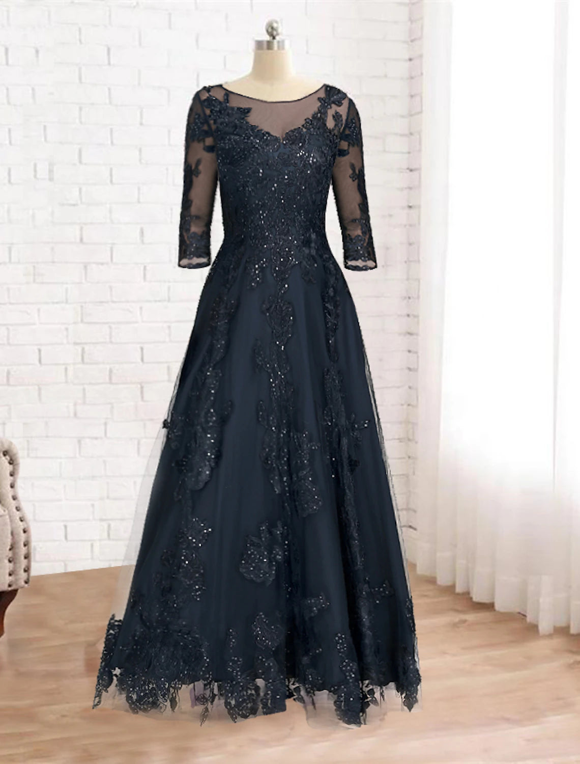 Side view of the navy A-line gown, showcasing sequin lace details and floor length.
