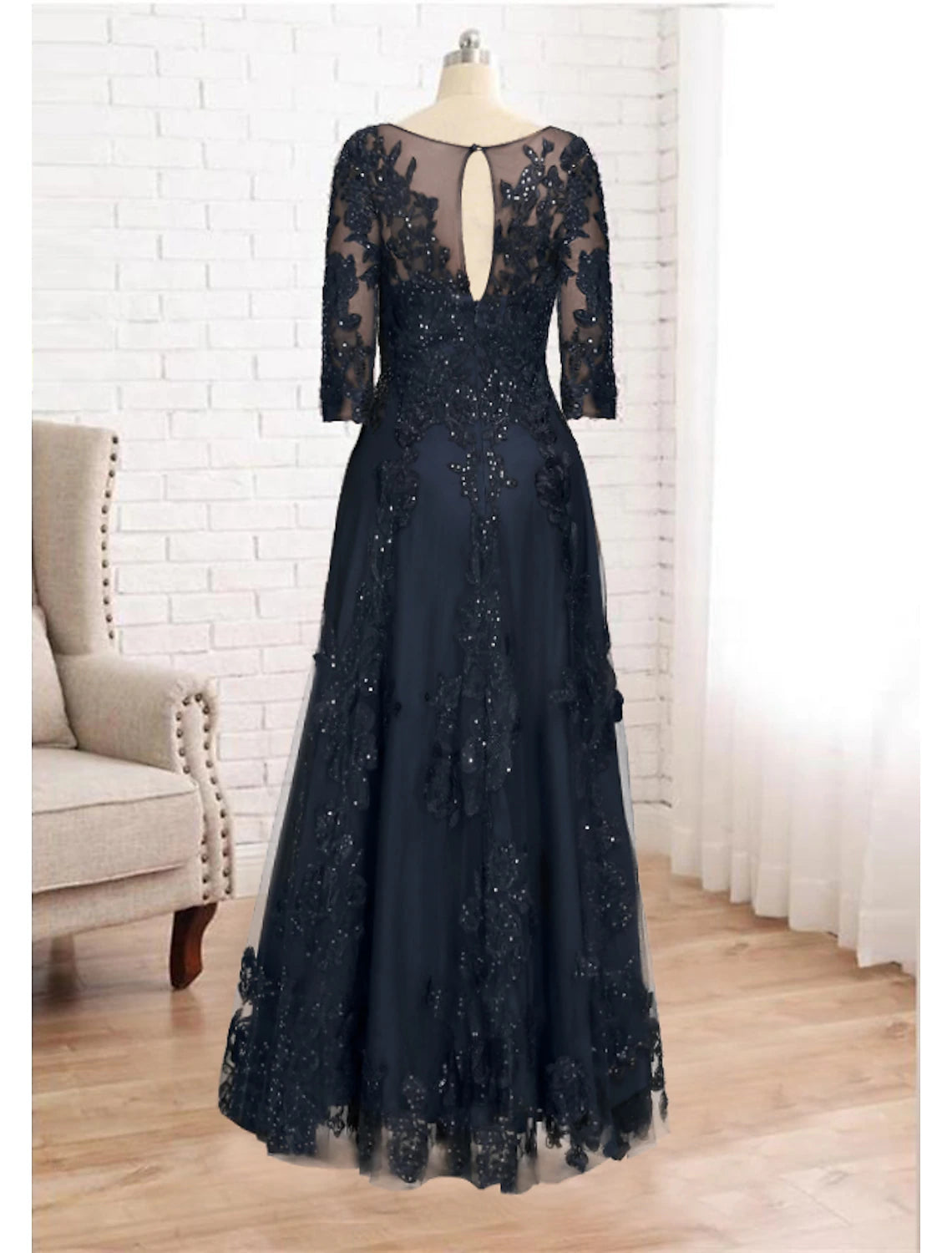 Back view of the luxurious navy mother of the bride dress with elegant drape.