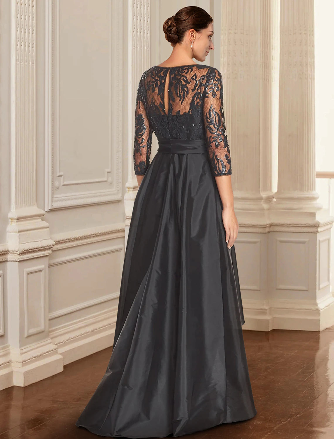 Elegant black A-line Mother of the Bride dress, back view with lace and bow details.