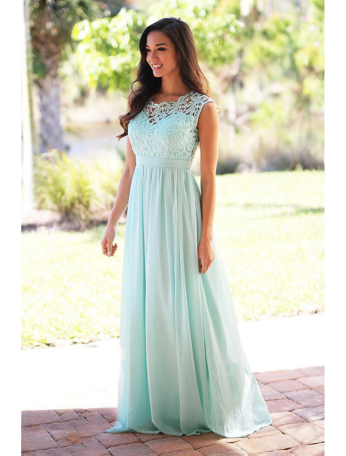Close-up of the flowing skirt and jewel neckline of a blue A-line bridesmaid dress.