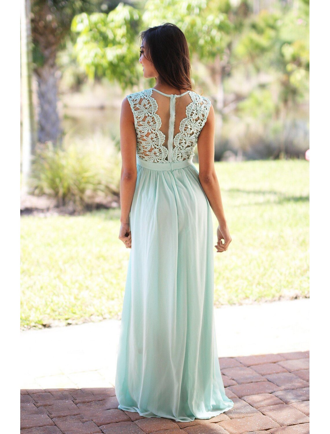 Full view of a woman in a graceful blue floor-length A-line bridesmaid gown.