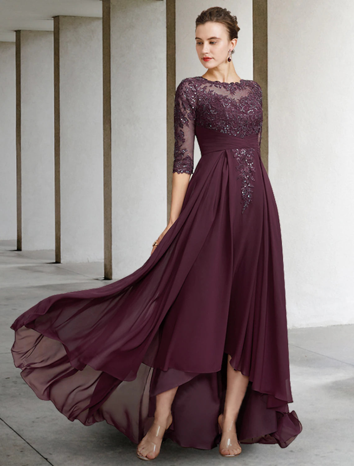 Elegant A-line mother of the bride dress with jewel neck, half sleeves, and high-low chiffon lace skirt.