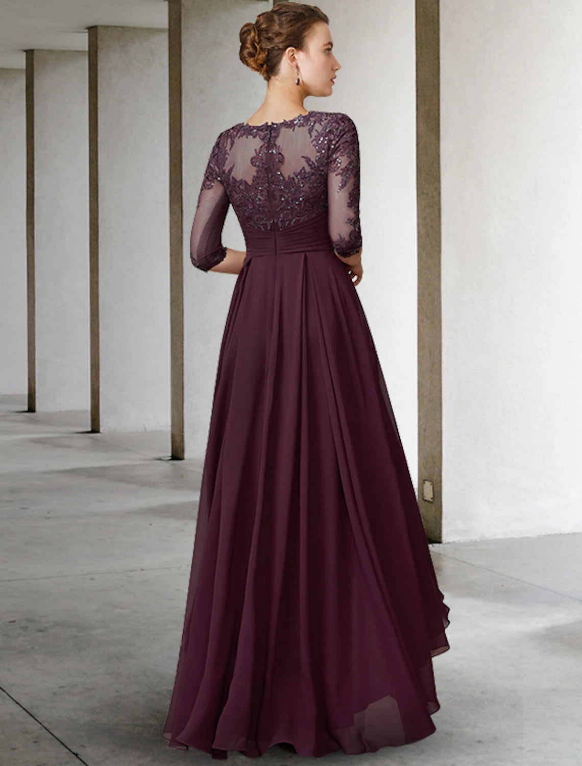 Full view of the elegant A-line mother of the bride dress featuring intricate lace and pleat details.