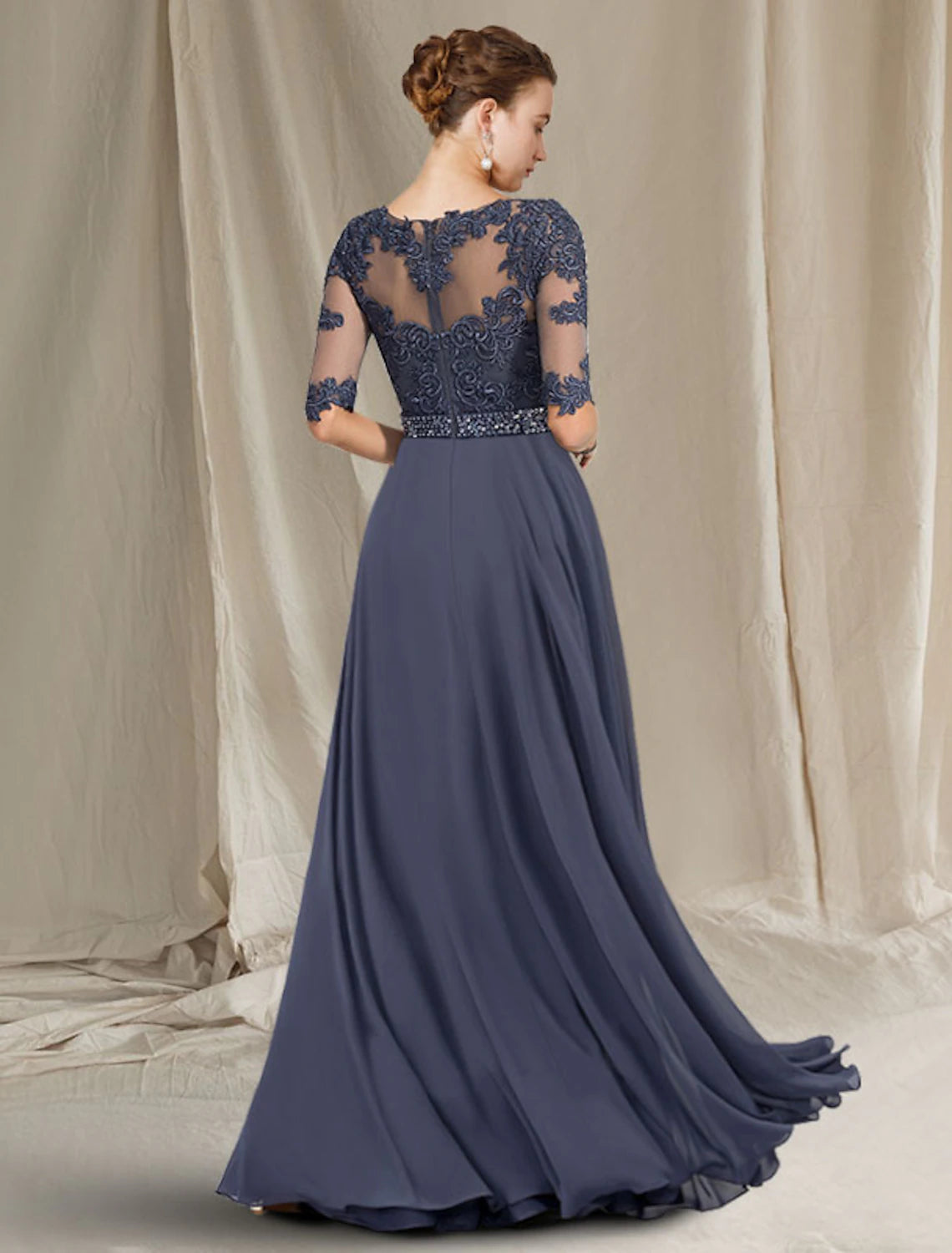 Back view of the floor-length chiffon and lace mother of the bride gown.