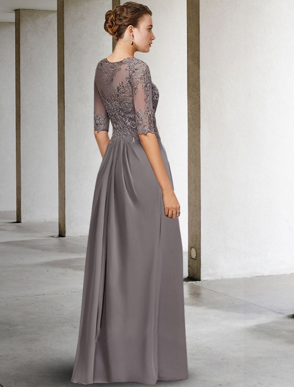 Back view of the A-line floor length gown, showing pleats and flowing skirt.
