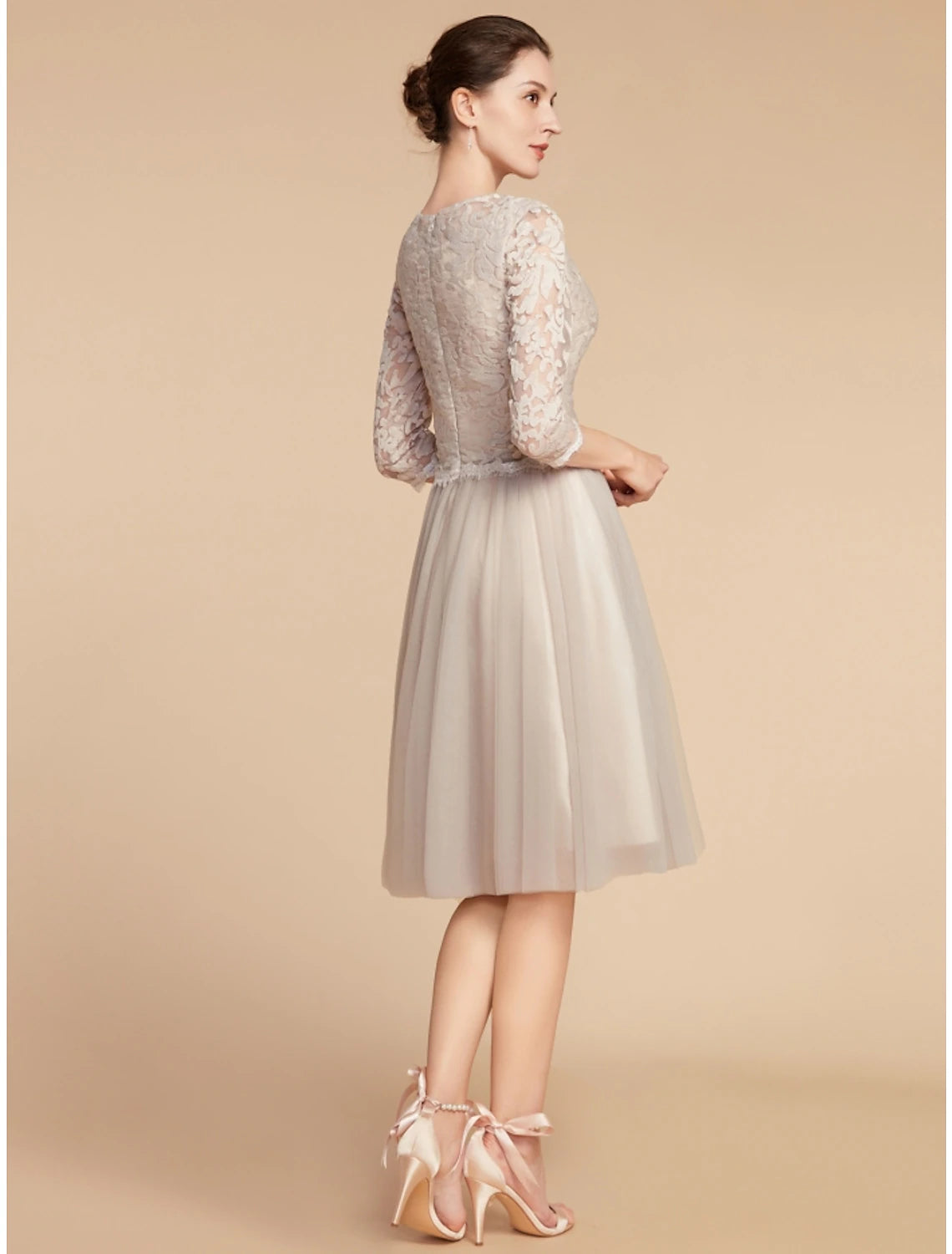 Back view of the knee-length A-line dress with delicate lace details.