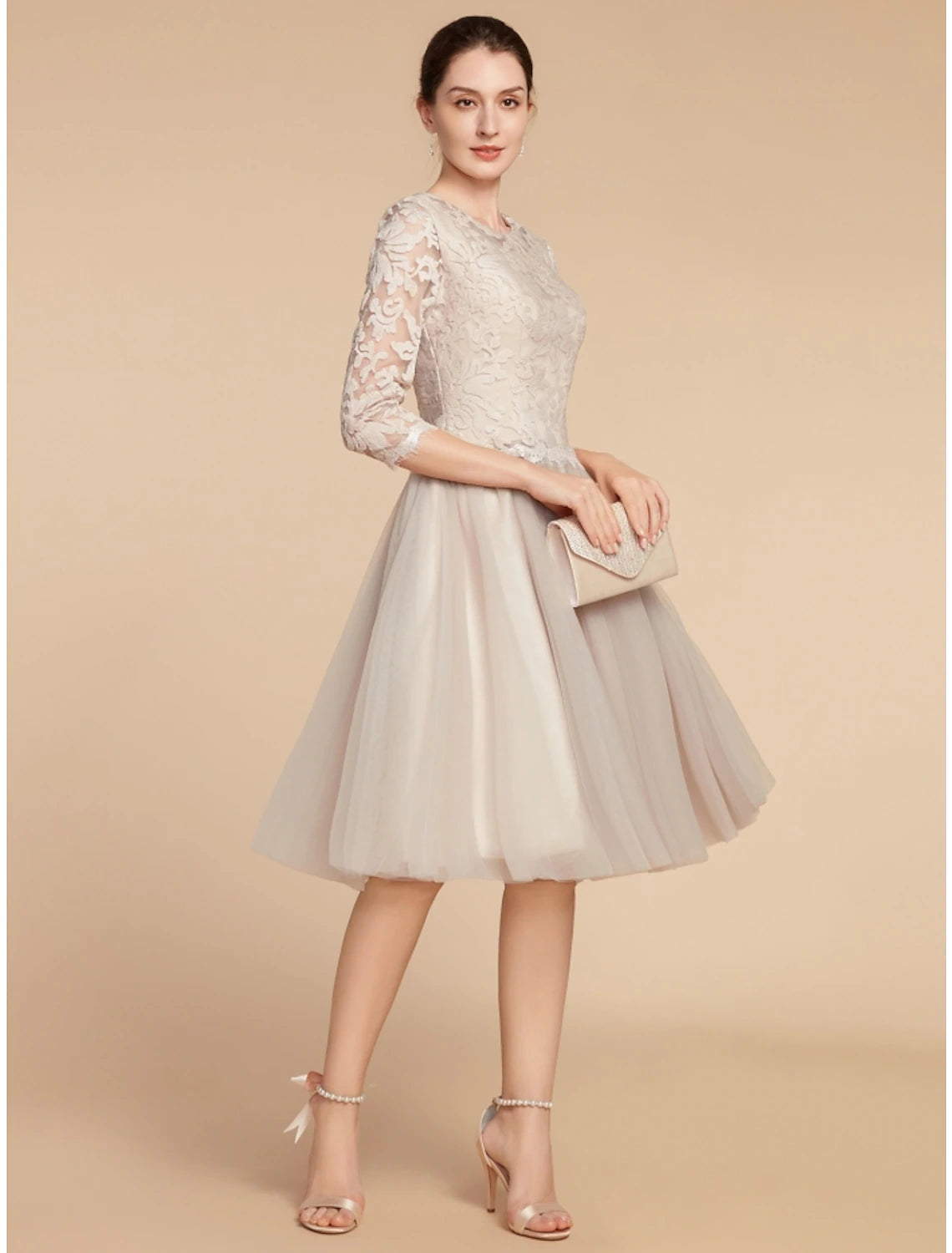 Close-up of the intricate lace and soft tulle fabric on the dress.