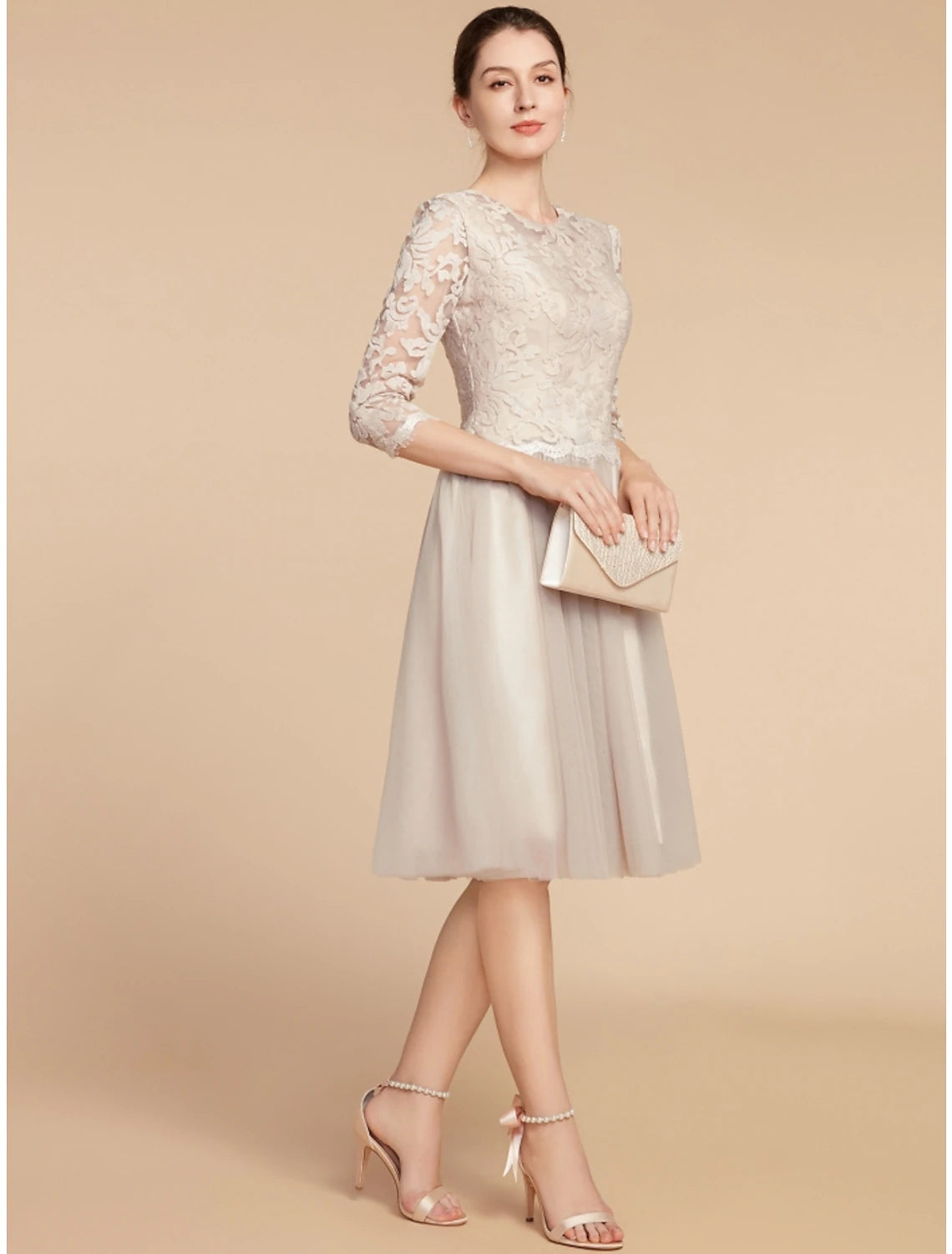 Model gracefully posing in the A-line half sleeve wedding guest dress.