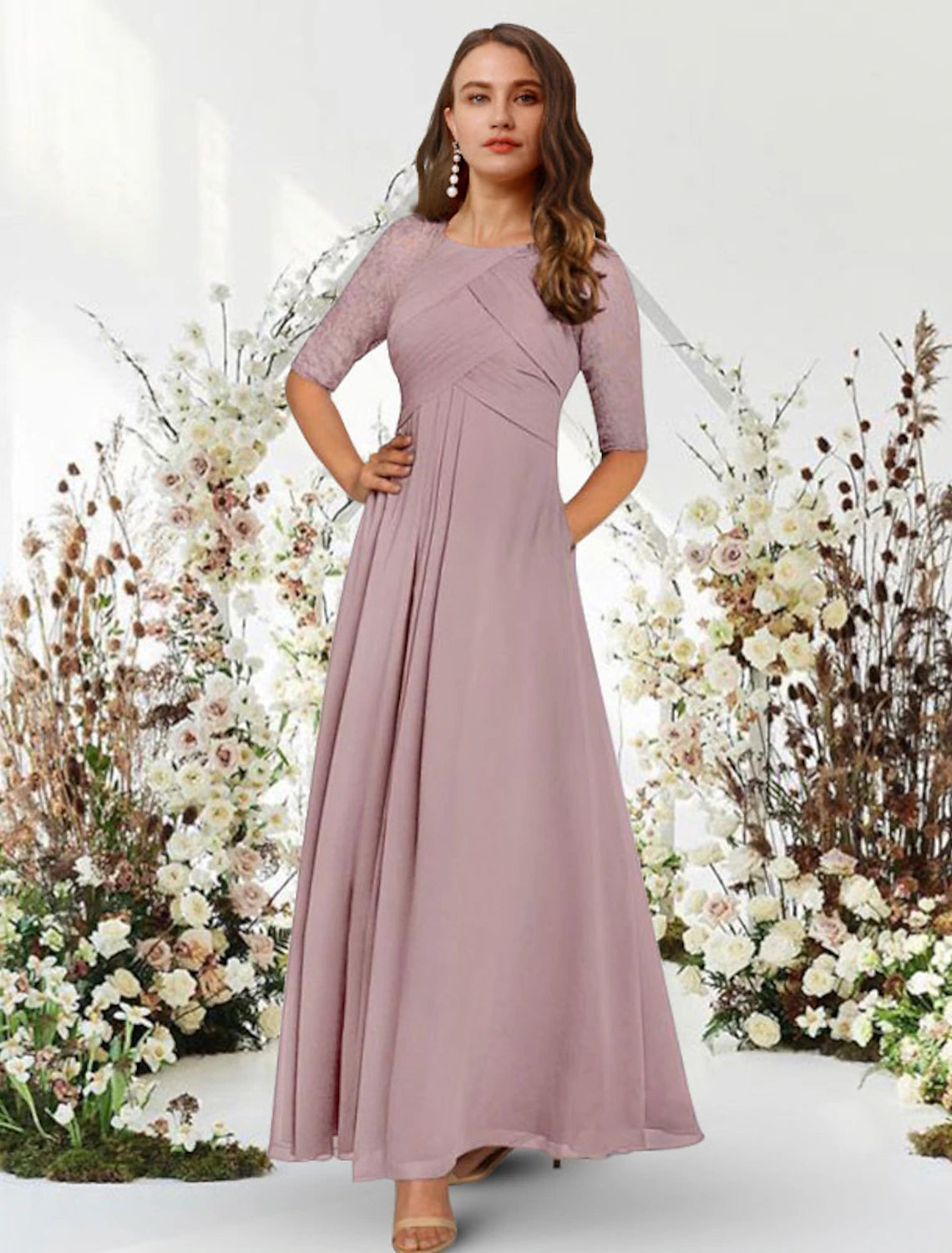 Woman wearing an elegant navy A-line chiffon evening gown with half sleeves and a jewel neck.