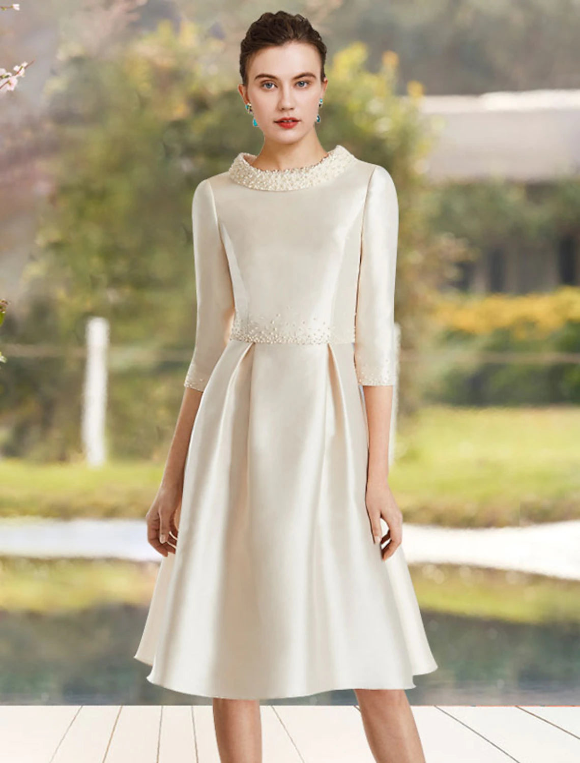 Elegant A-line satin dress with jewel neck and half sleeves, featuring delicate beading, perfect for a wedding guest.