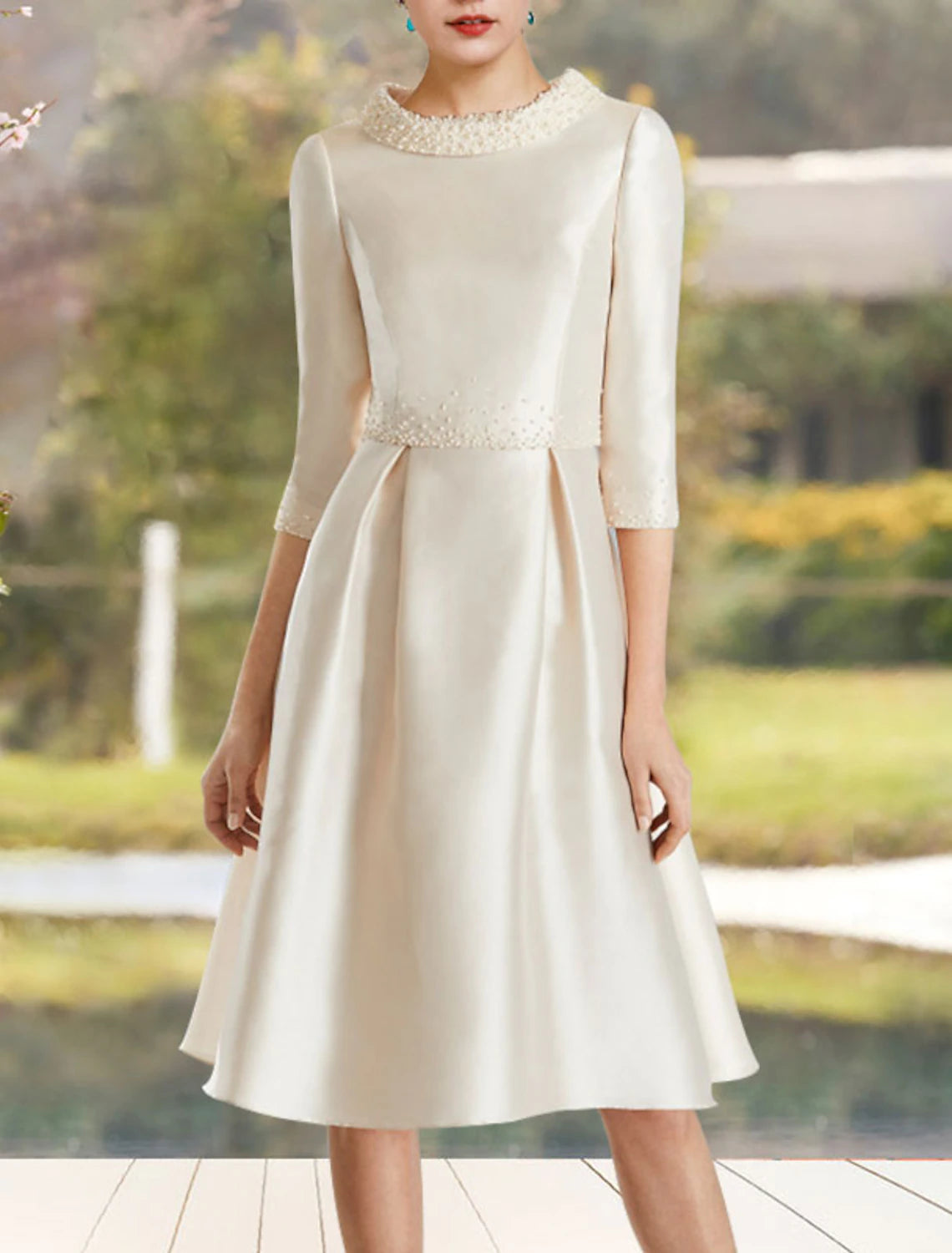Back view of the sophisticated A-line mother of the bride dress with a jewel neck and half sleeves.