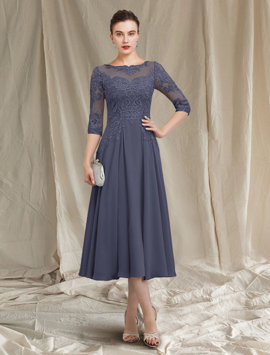 Elegant A-Line Mother of the Bride dress with jewel neck and half sleeves, front view.