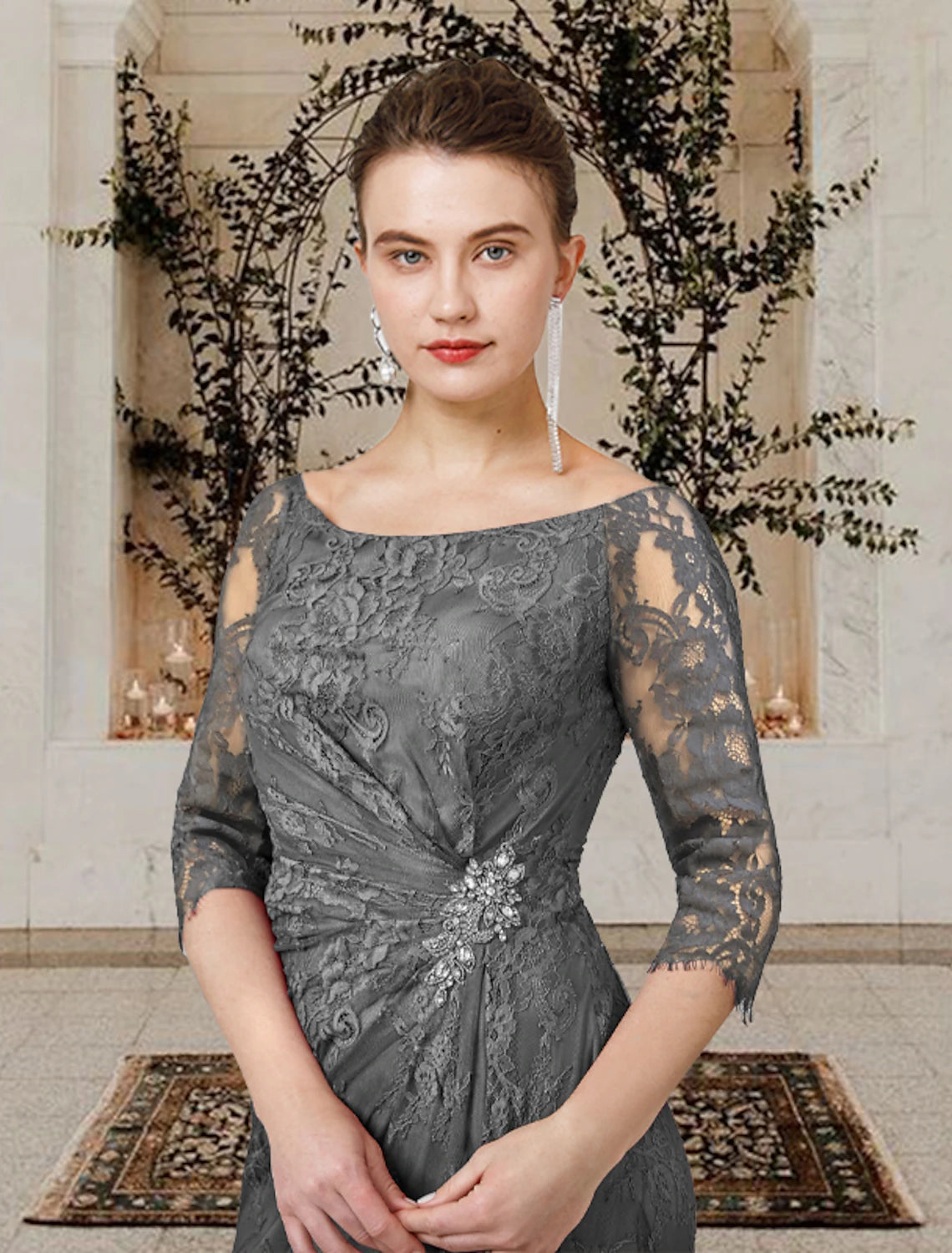 Close-up of the lace detail and crystal brooch on the dress.