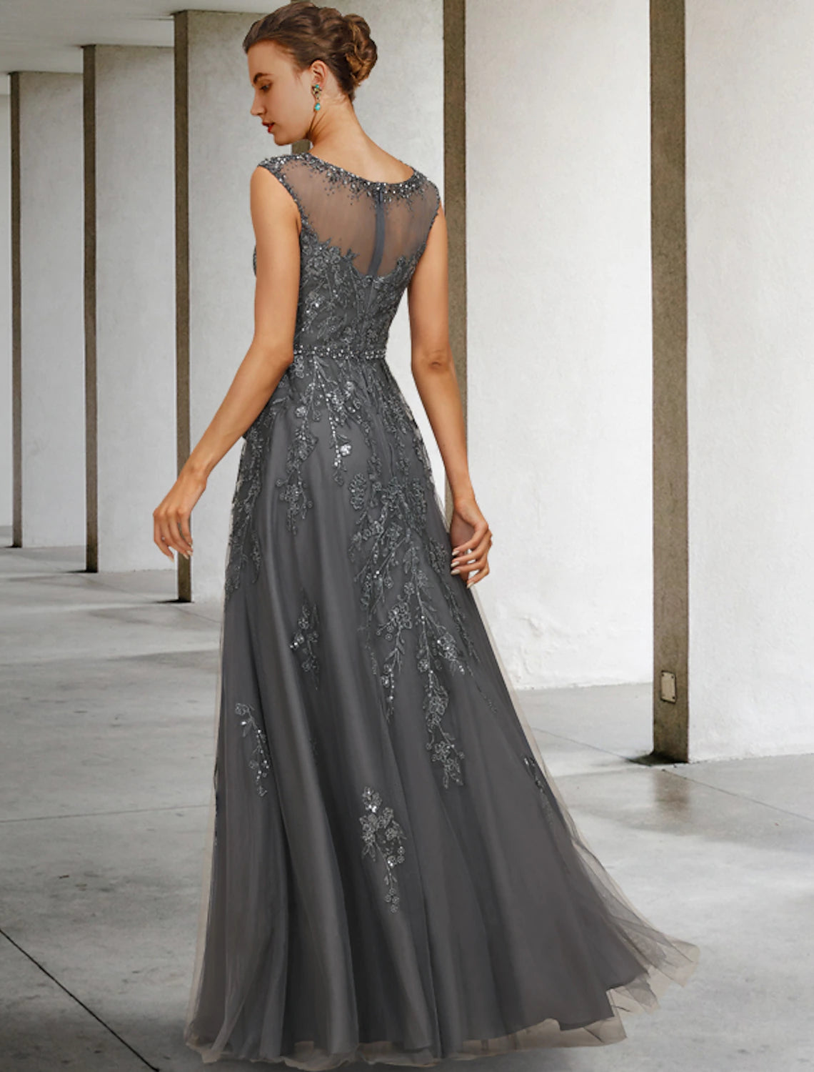 Close-up of the dress fabric showing intricate lace, beading, and sequin details.
