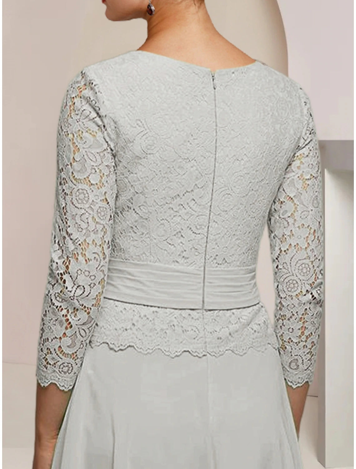 Close-up of the lace and pleat details on the chiffon formal dress.