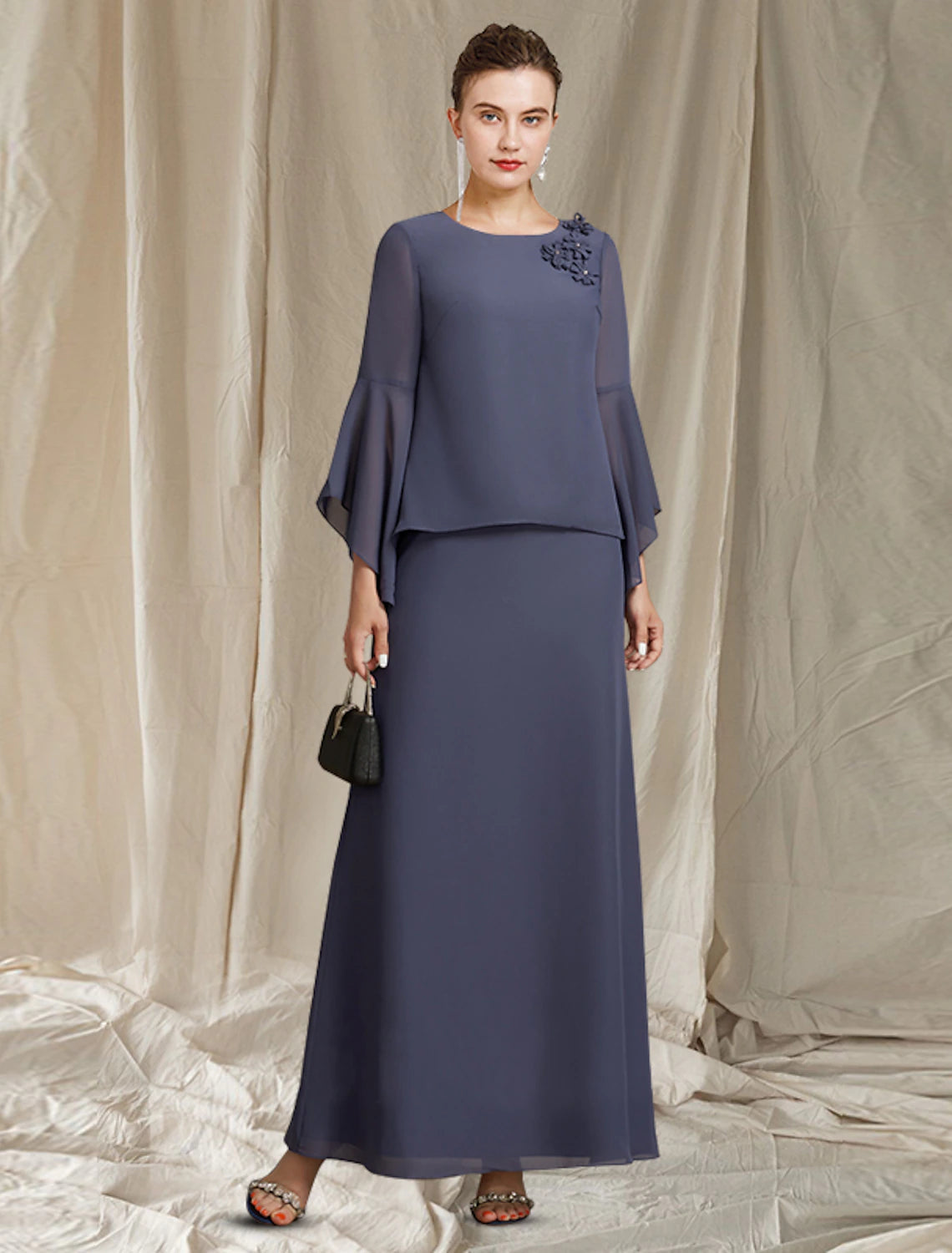 Elegant A-Line Mother of the Bride dress with jewel neck, long sleeves, and flower detail.