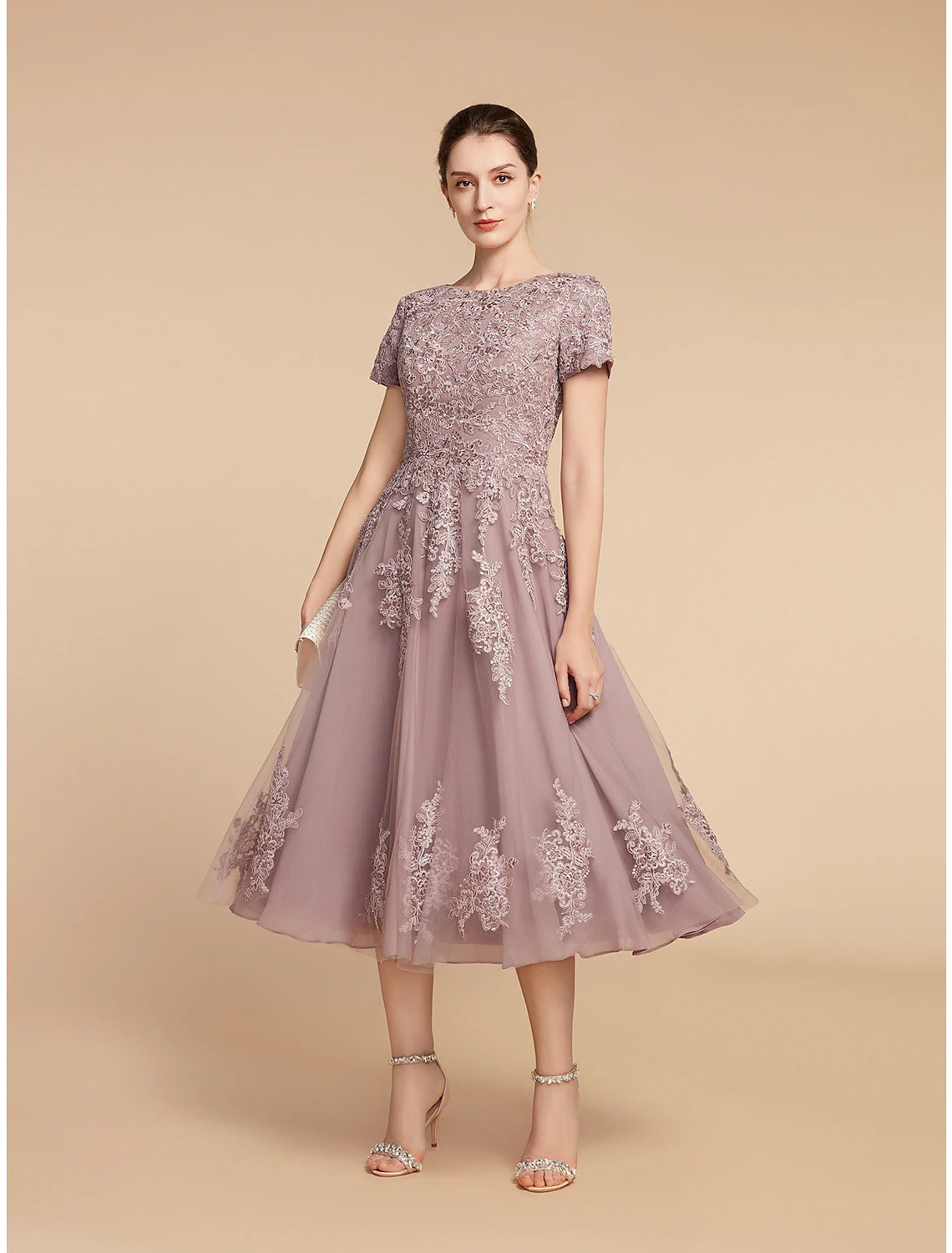 Side profile of the elegant Mother of the Bride dress with intricate appliques.