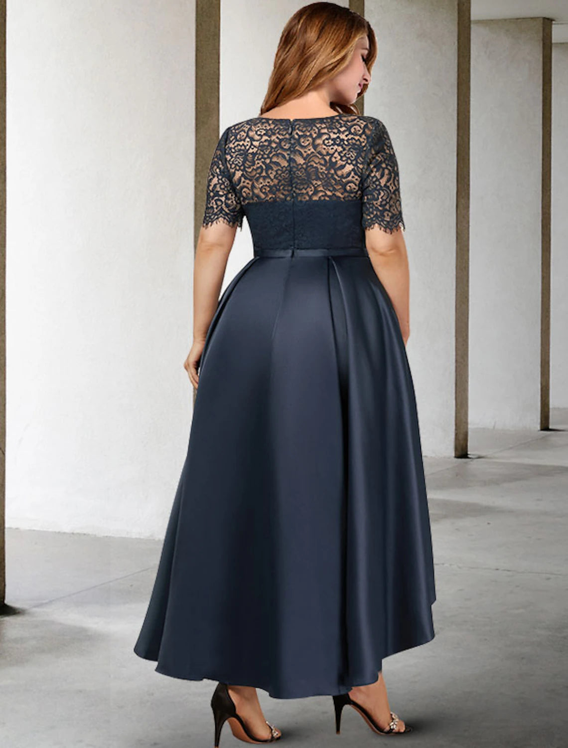 Back view of the A-line pleated satin formal dress with short sleeves.