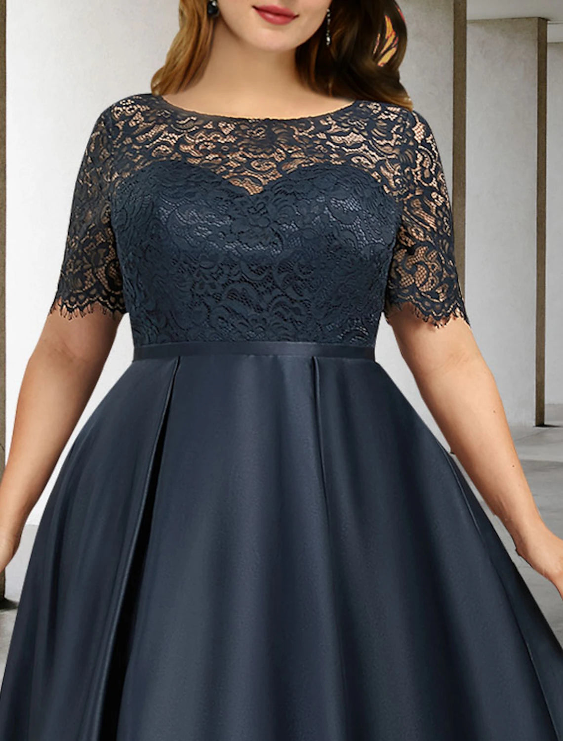 Side view of the elegant A-line mother of the bride dress with asymmetrical short sleeves.