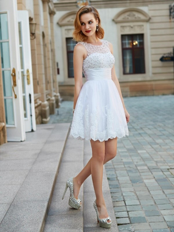 Close-up of the jewel neckline with pearl embellishments on the tulle dress.