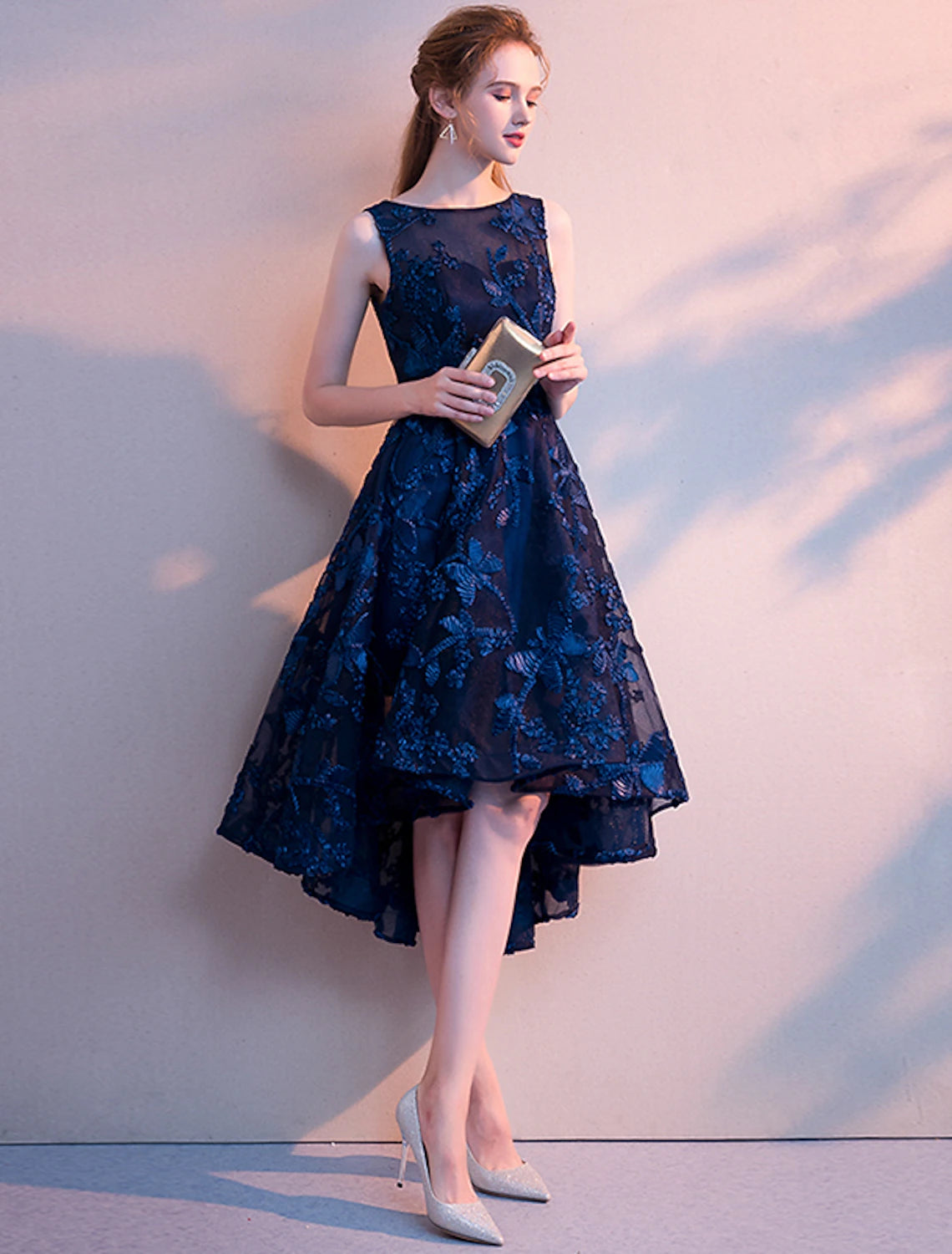 Detail of the jewel neck and pleated design on the Weitese dress.