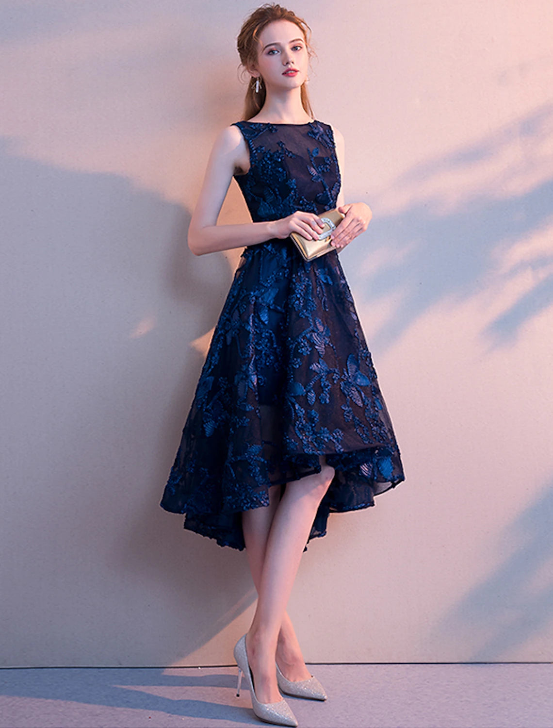 Detail of the pleated tulle skirt and asymmetrical design of the cocktail dress.