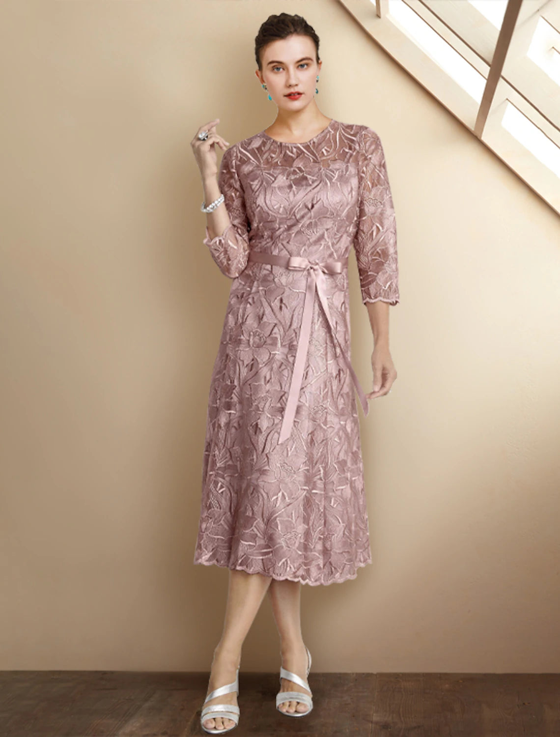 Elegant A-Line Mother of the Bride dress with jewel neck and 3/4 lace sleeves.