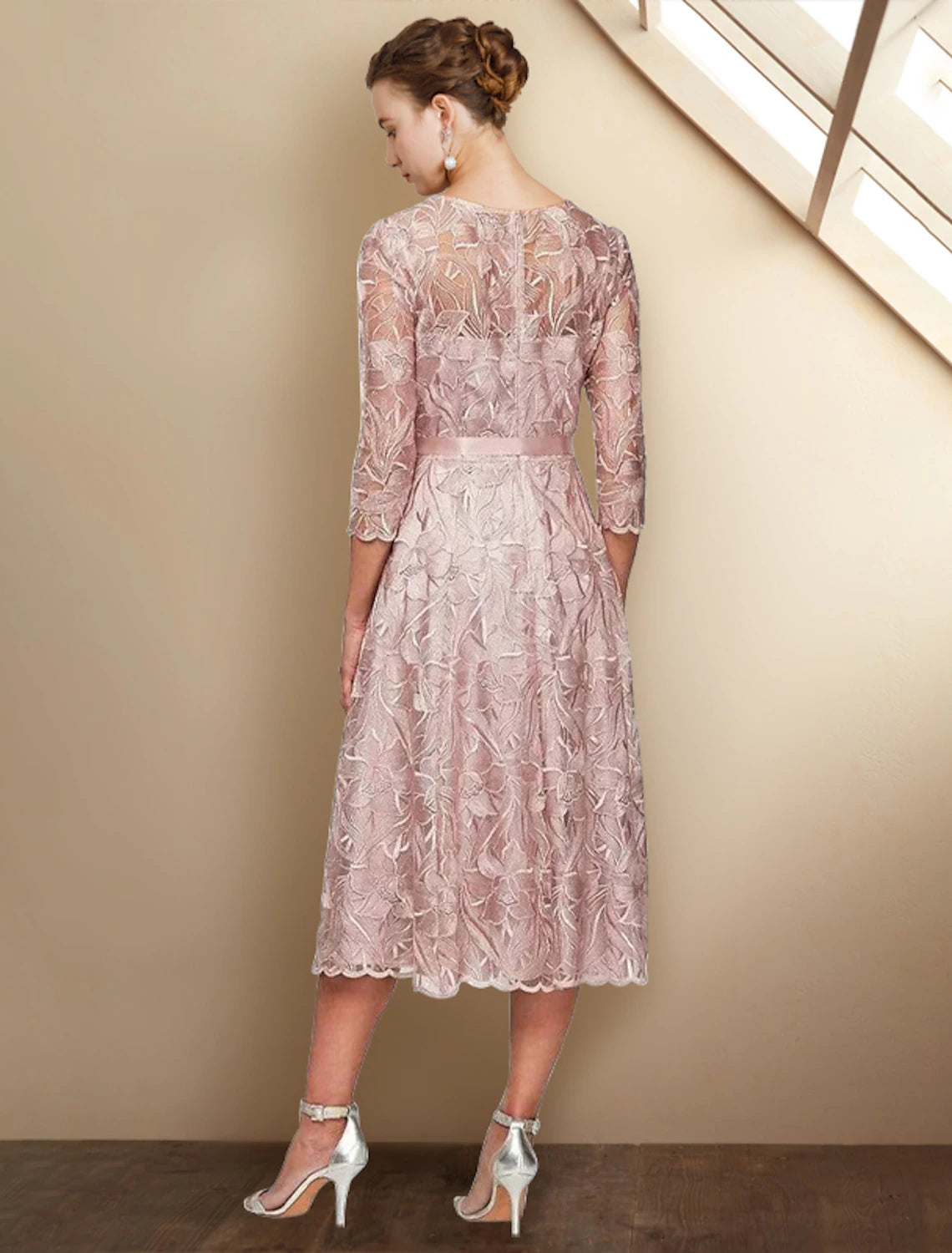 Back view of the tea-length Mother of the Bride dress with sash bow detail.