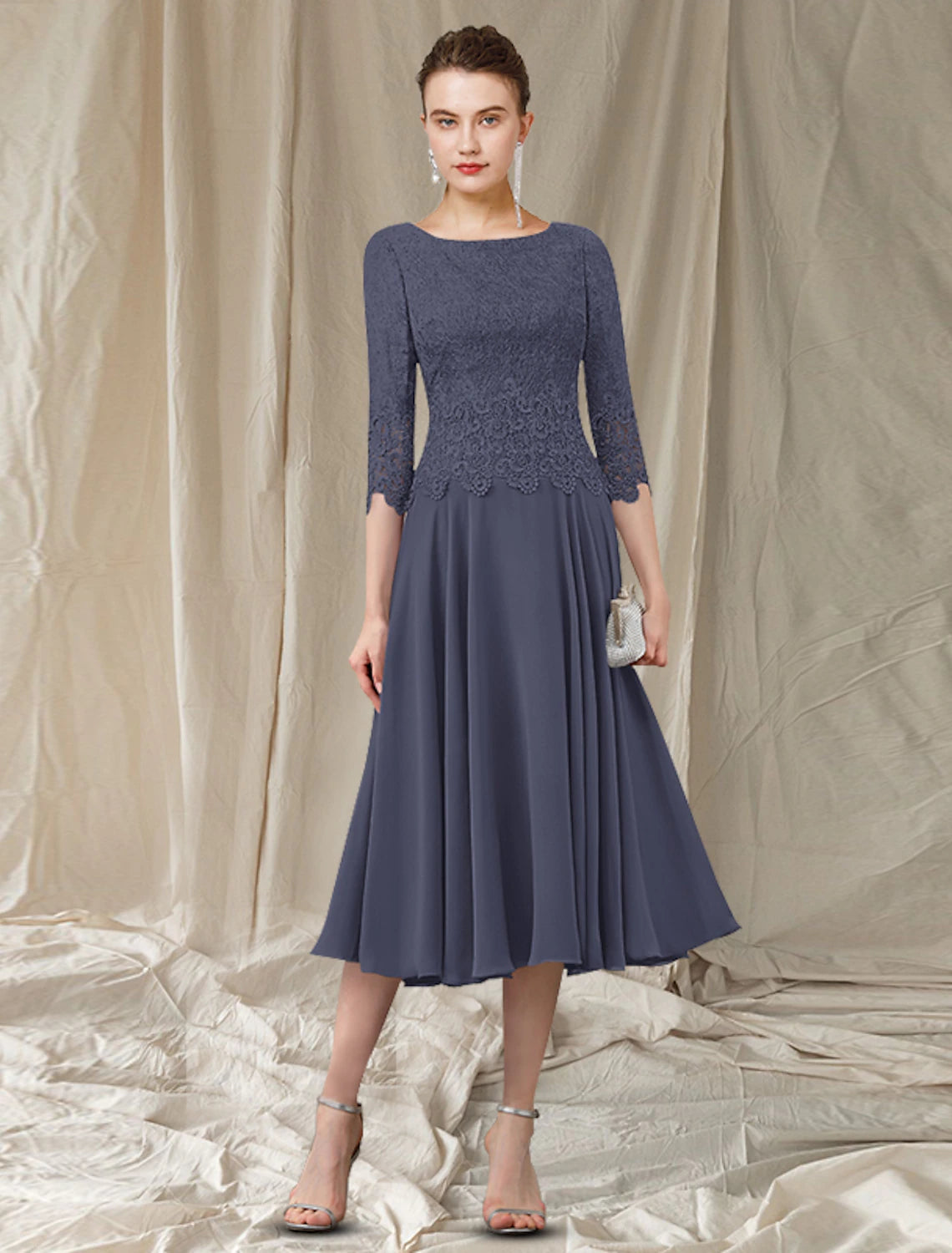 Elegant A-Line Mother of the Bride dress with jewel neck, 3/4 lace sleeves, and tea length silhouette.