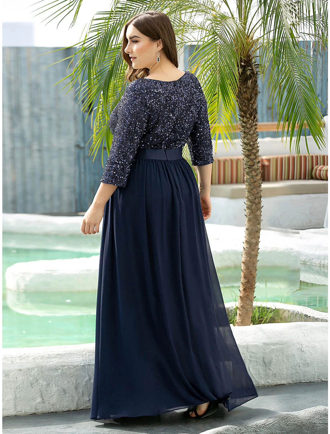 Side view of the A-line jewel neck dress with sequin details.