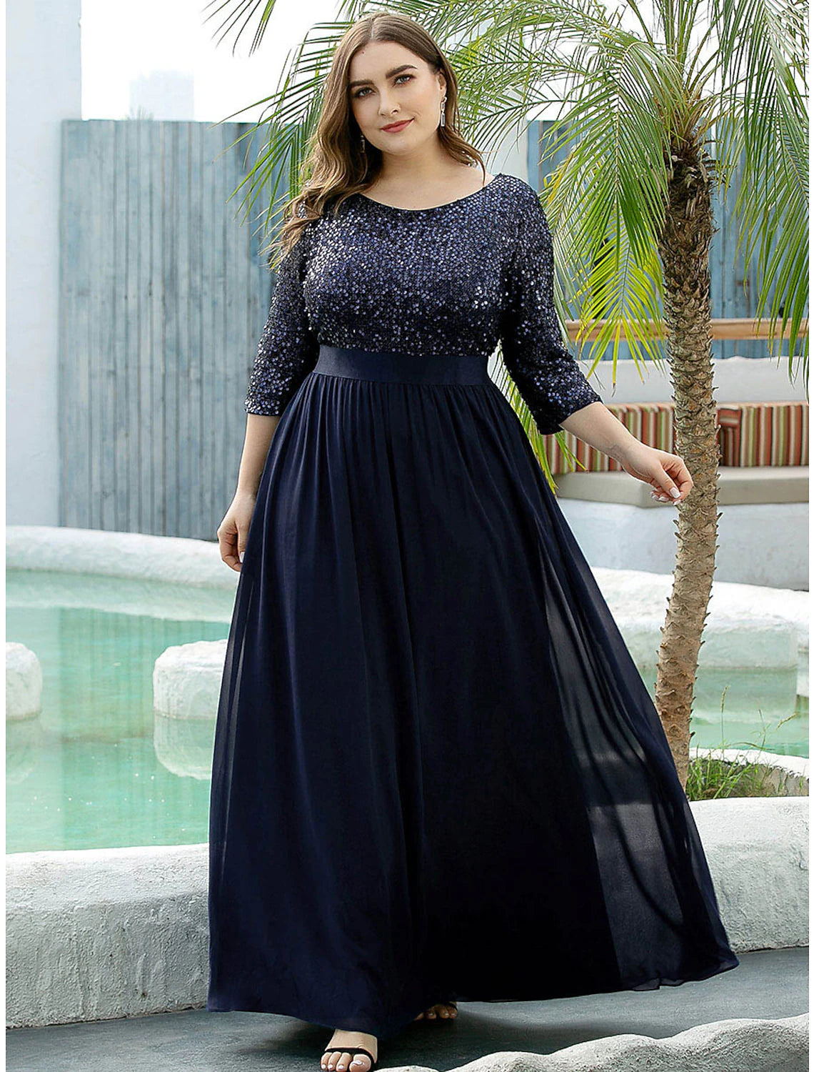 Close-up of the sequined tulle fabric and 3/4 sleeve detail.
