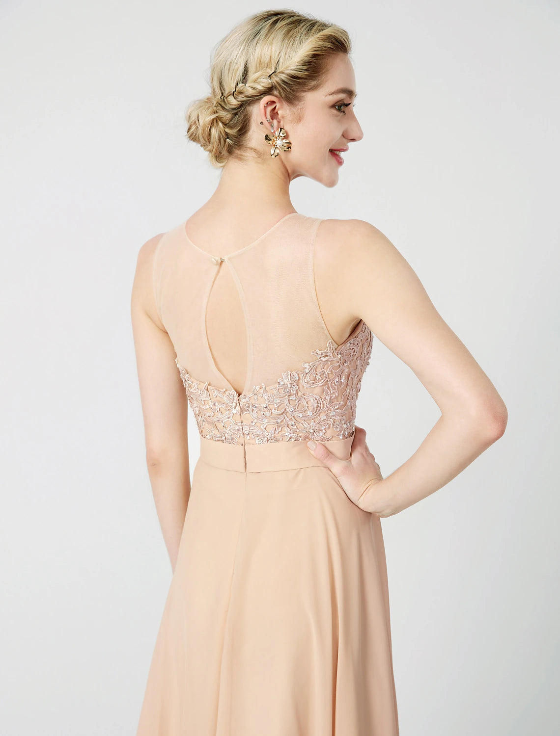 Detail of the delicate beaded lace appliques on the bodice of the dress.