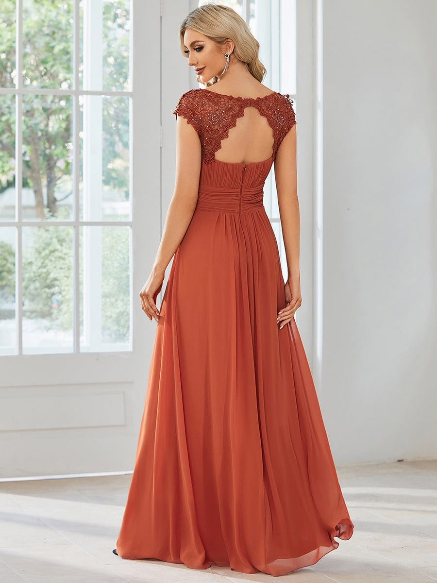 Side view of a model in an elegant blue lace cap sleeve gown.