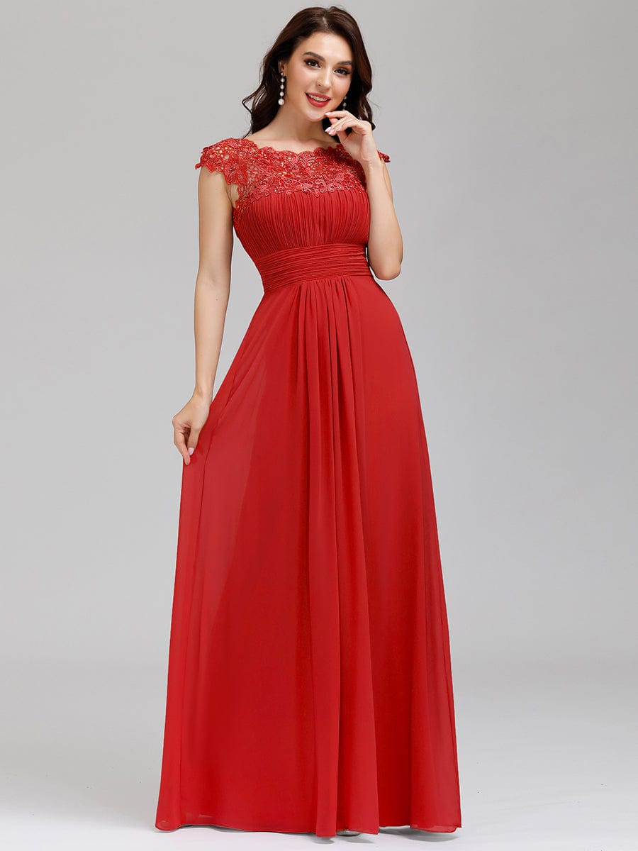 Model wearing a floor-length red lace cap sleeve bridesmaid dress.