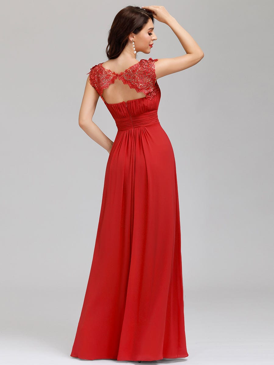 Side view of a model in an elegant red lace cap sleeve gown.