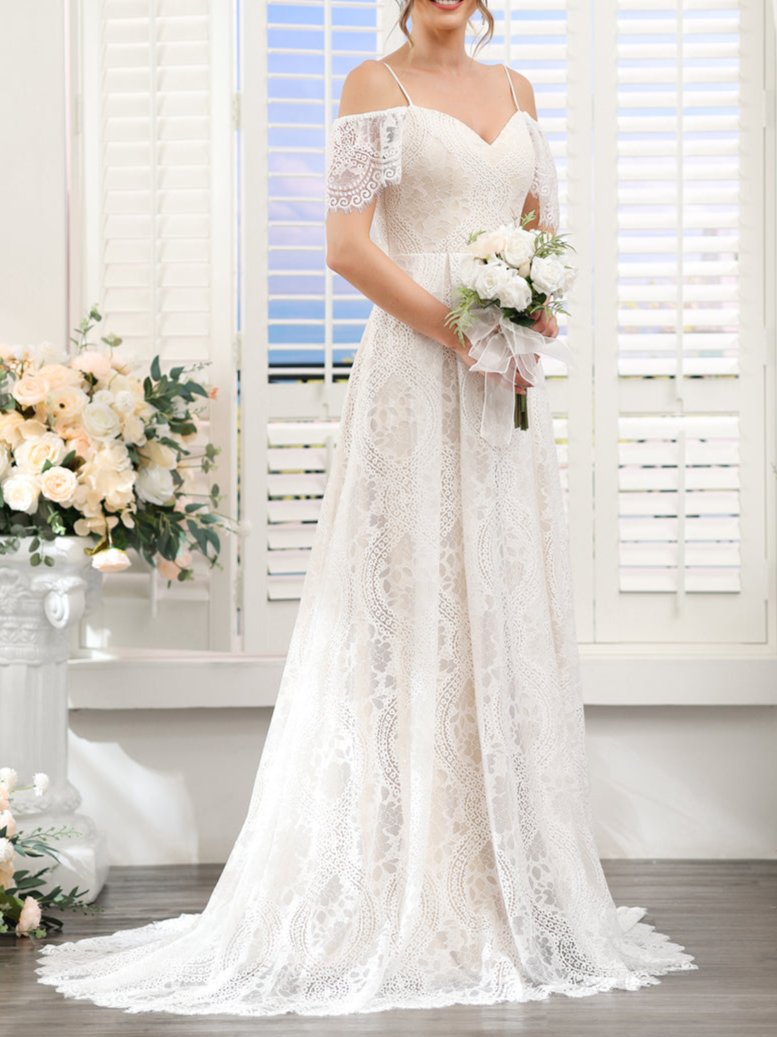 Full length view of the romantic A-line lace bridal gown.