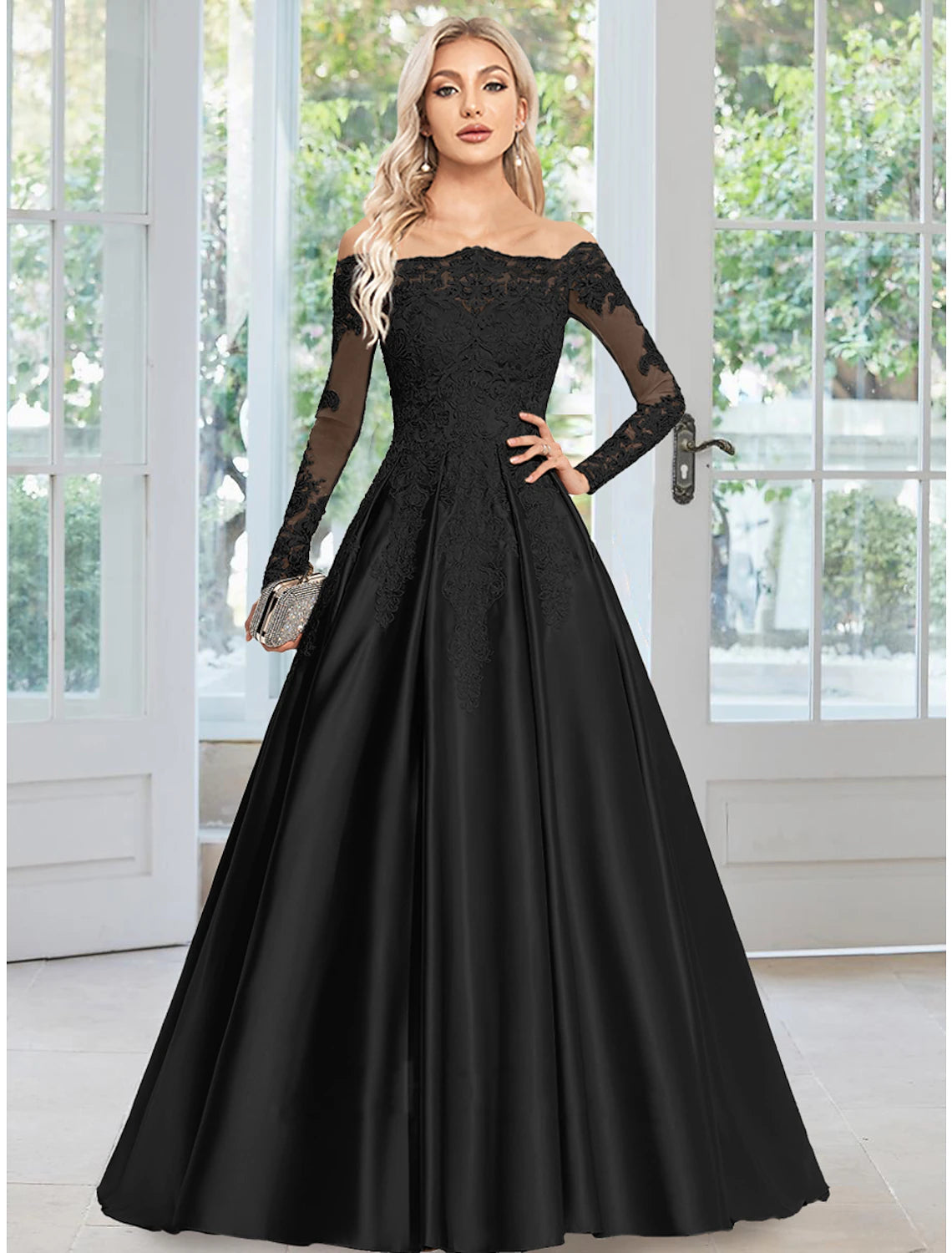 Woman wearing an elegant A-line off-shoulder satin evening gown with floral appliques.