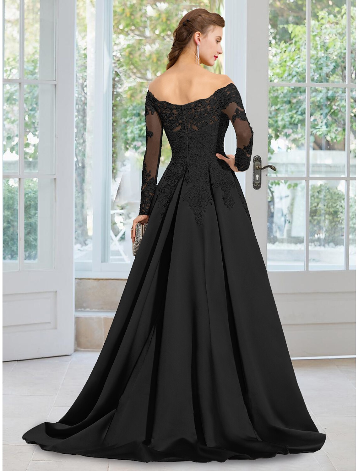 Back view of the black A-line off-shoulder long-sleeve evening gown, showcasing the floral lace and court train details.