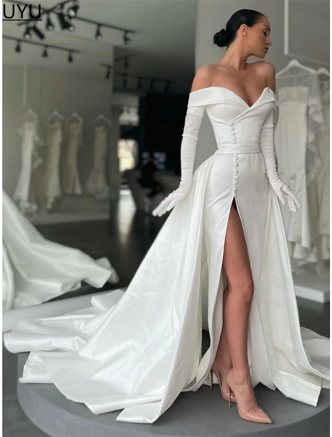 Side view of the black A-line off-shoulder satin evening gown, showcasing its long sleeves and flowing court train.