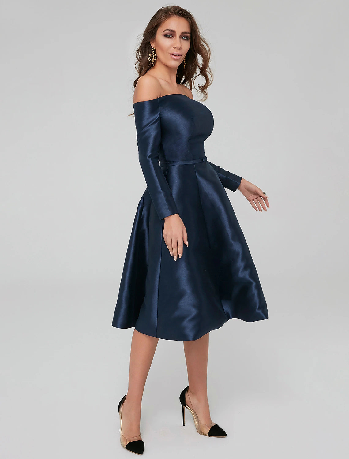 Close-up of the off-shoulder neckline and long sleeves of the dress.