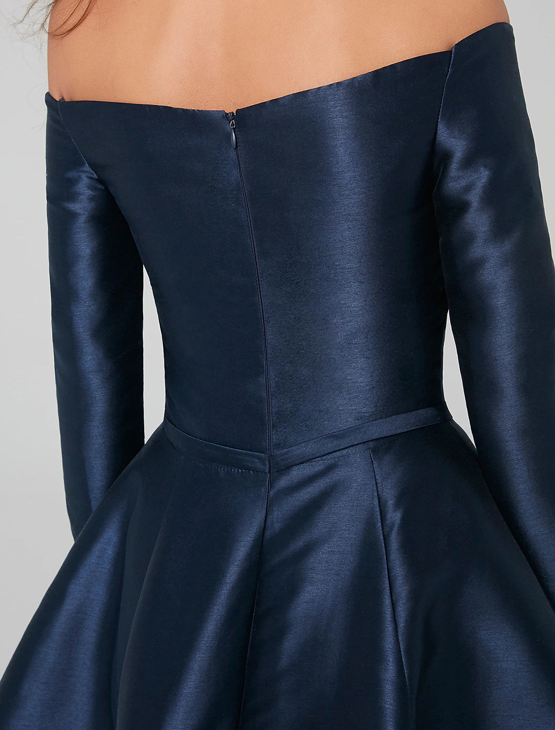 Woman smiling, highlighting the elegant fit of the special occasion dress.
