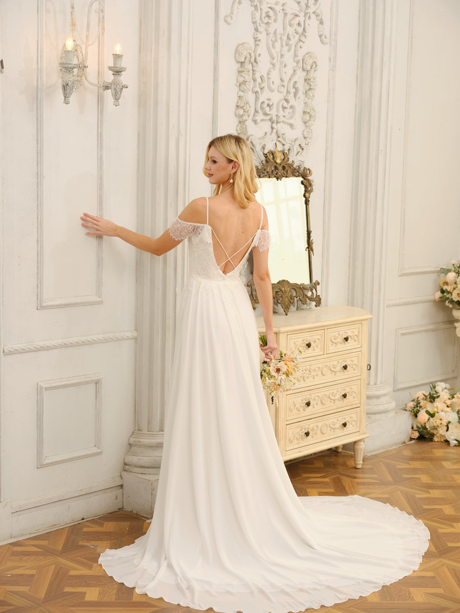 Close-up of the off-shoulder neckline and intricate appliques on the wedding dress bodice.