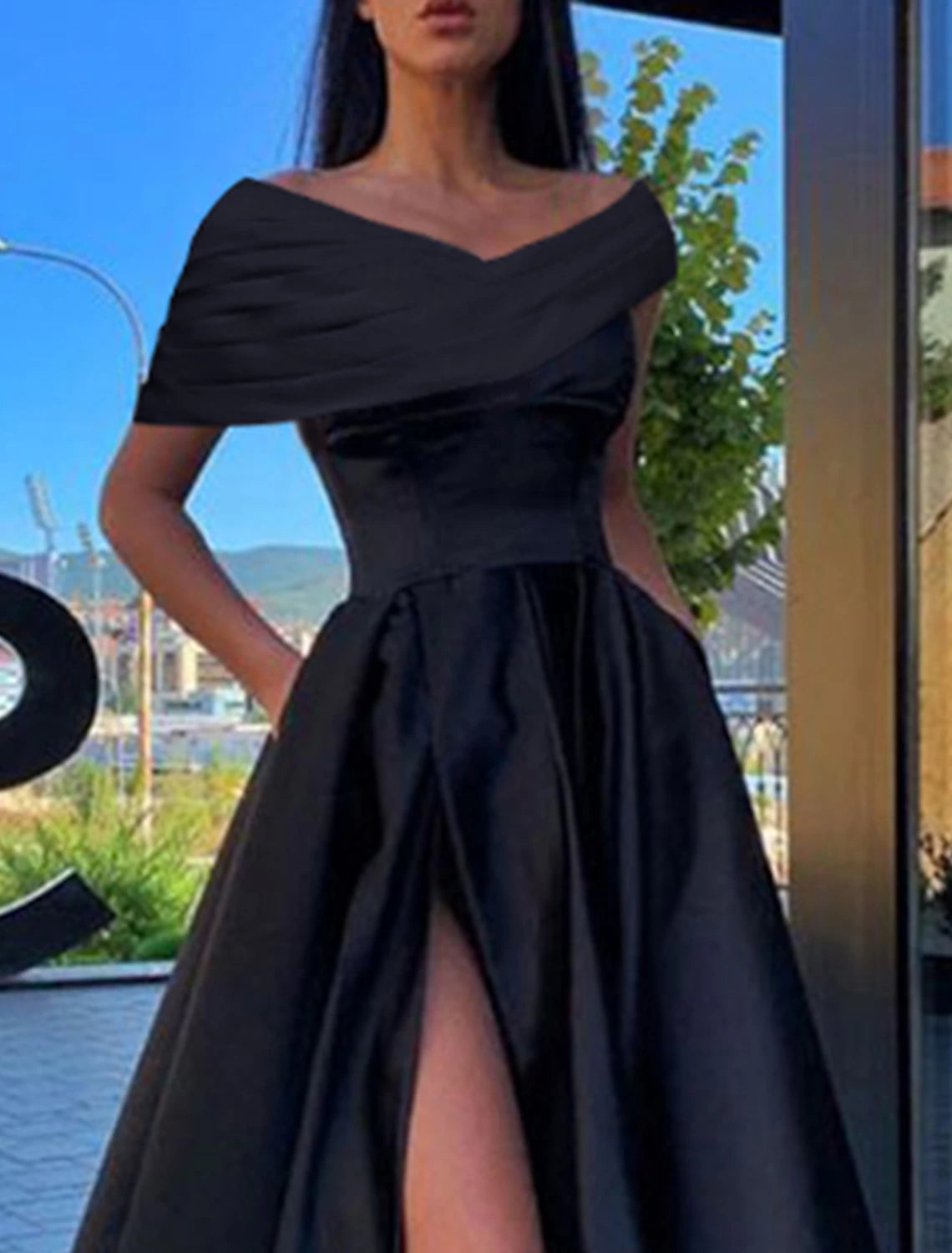Back view of the black A-line off-shoulder short-sleeve satin dress, highlighting the elegant silhouette.