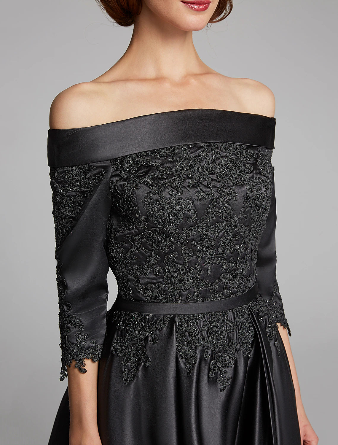 Detail of the lace sash and 3/4 sleeves on the formal dress.