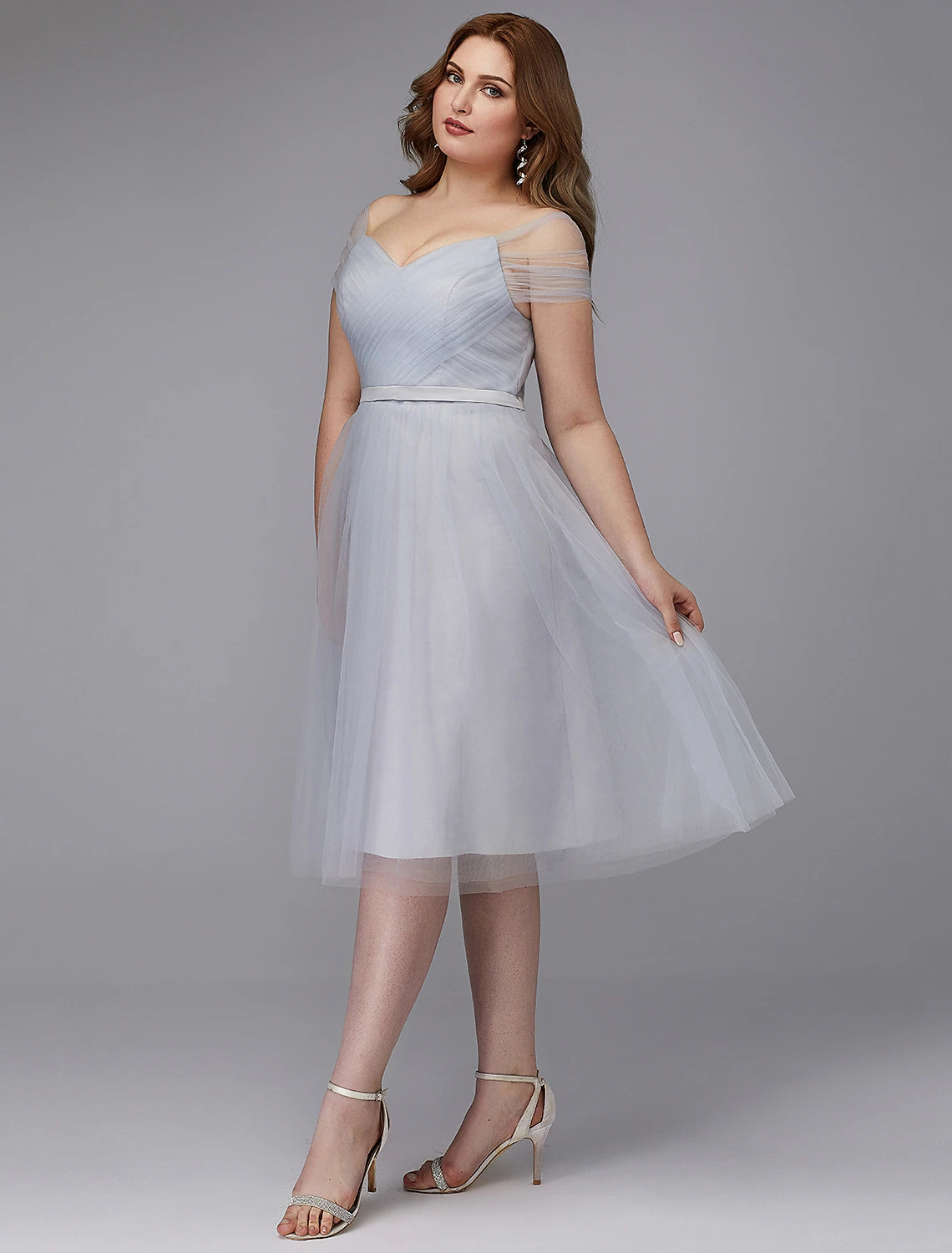 Back view of the elegant off-shoulder A-line tulle dress, highlighting the criss-cross detail and sash.