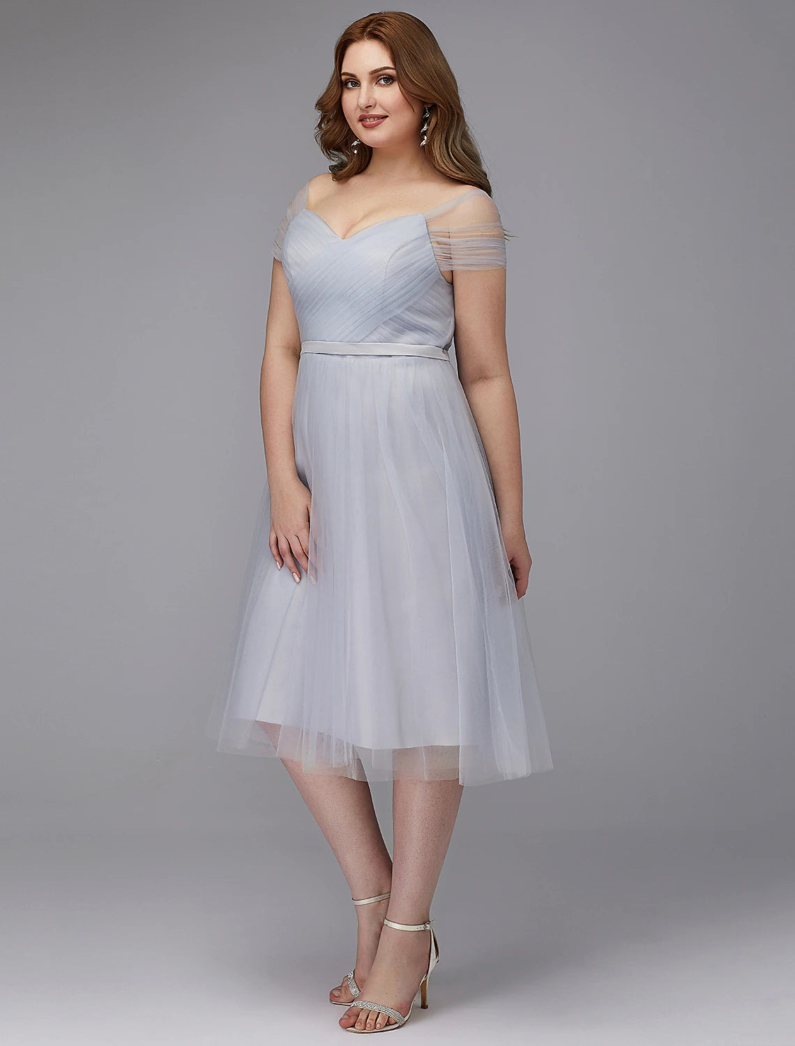 Close-up of the off-shoulder neckline and short sleeves of the tulle dress.